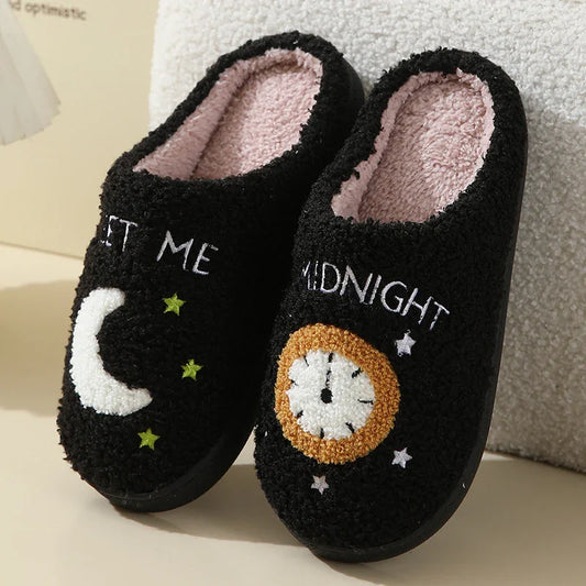 Plush slippers with moon and clock print.